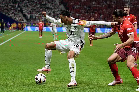 Jamal Musiala is challenged by Ricardo Rodriguez